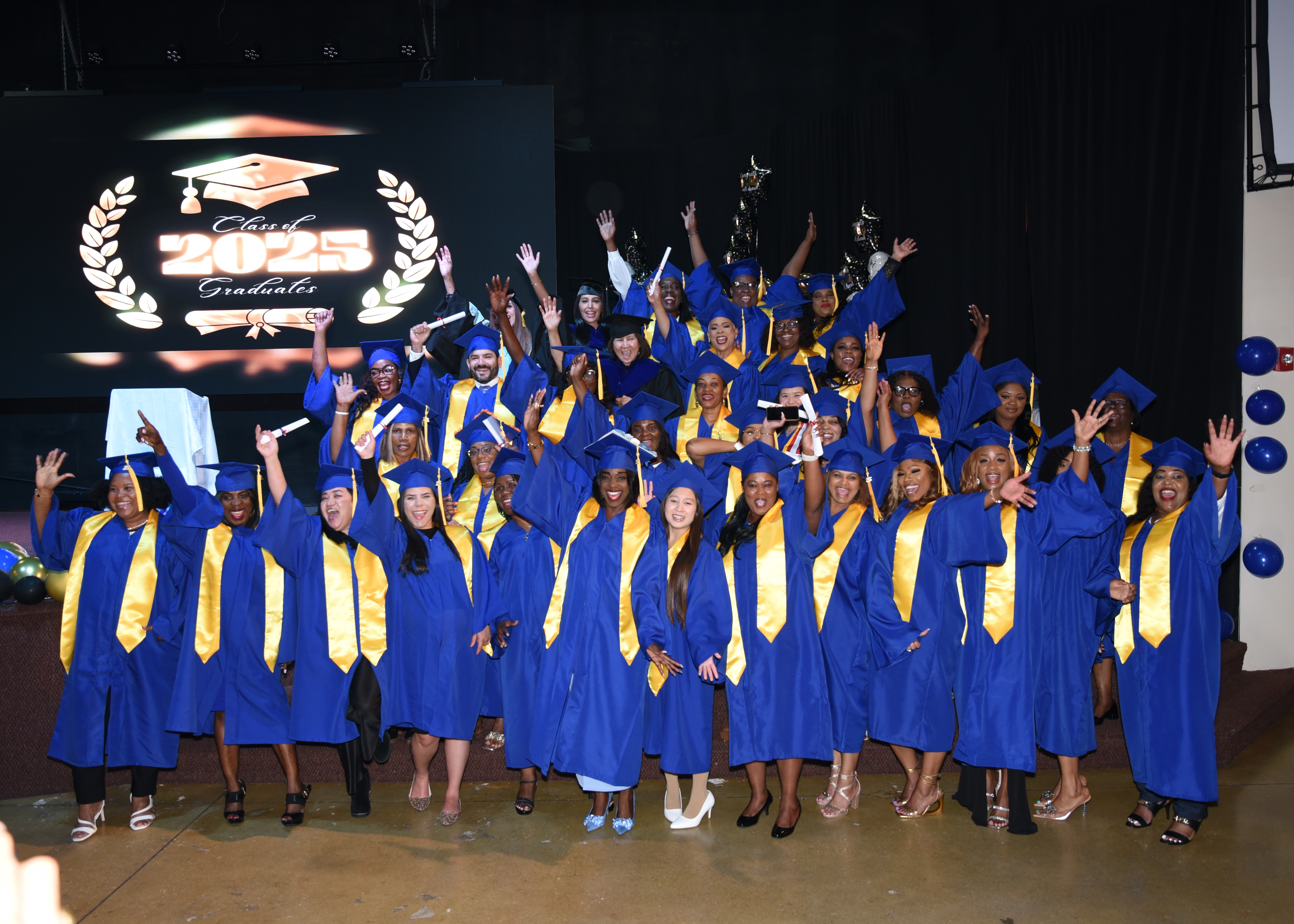 Graduates celebrating on stage